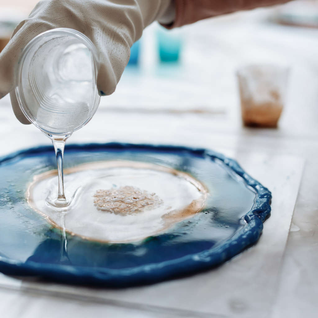 A person pouring resin