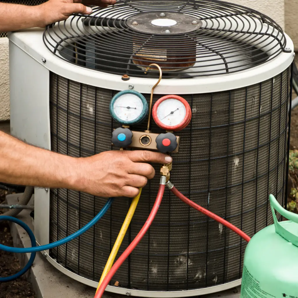 Man charging an AC unit with a Freon AC Refrigeration Charging Manifold...